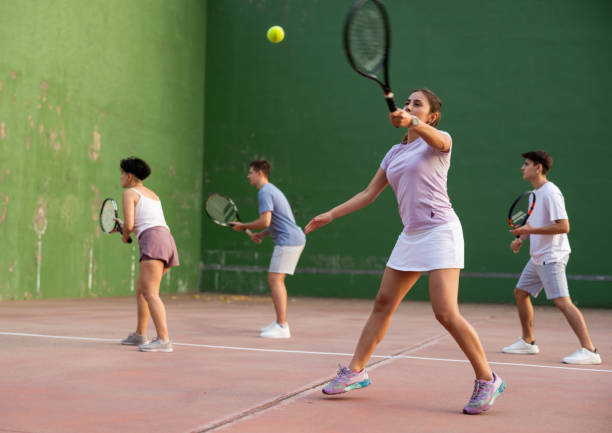istock Woman pelota player hitting ball with racket 1443408596