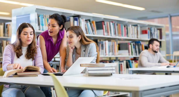 istock Three female friends studying together at library 1443408749