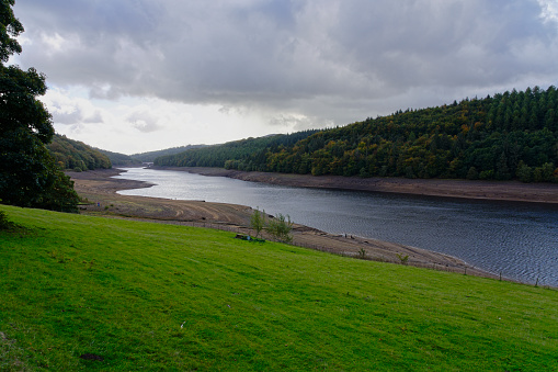Dark rain clouds gather over the receding waters of the Ladybower reservoir in Hope Valley, Derbyshire