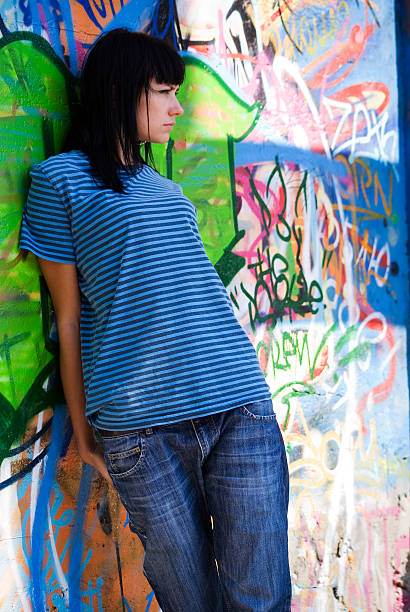 istock Beautiful girl by the wall 144341178