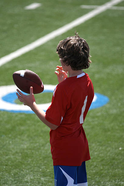 istock Boy playing with football 144341507
