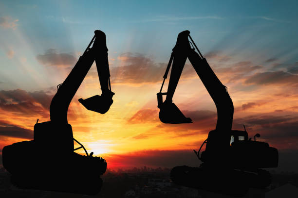 istock Two Black silhouette of backhoe loader . 1443419398