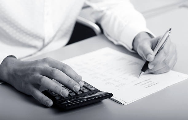 istock businessman calculating expenses at tax time 144341999