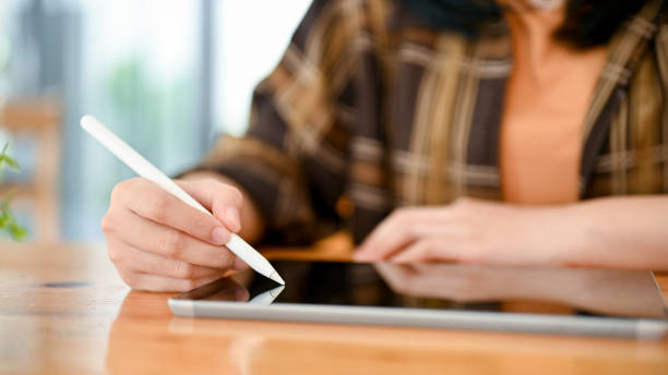 istock An Asian female college student or freelancer in flannel shirt using digital tablet 1443421845