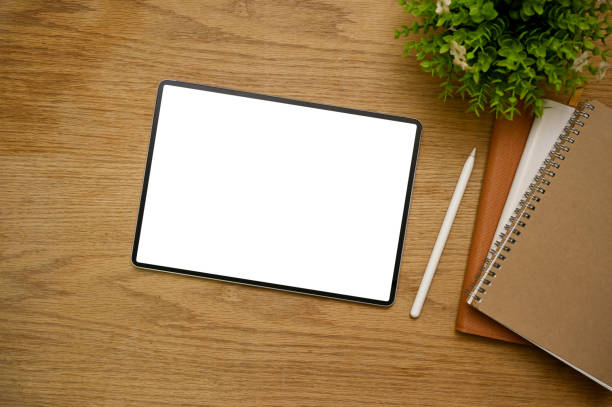 istock Workspace top view with digital tablet mockup on wood tabletop background. 1443421922