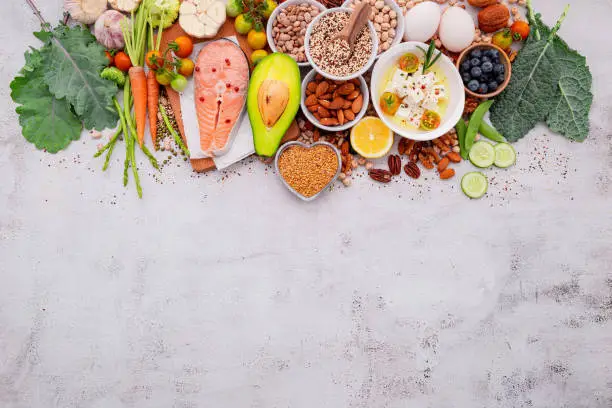 Photo of Ketogenic low carbs diet concept. Ingredients for healthy foods selection set up on white concrete background.