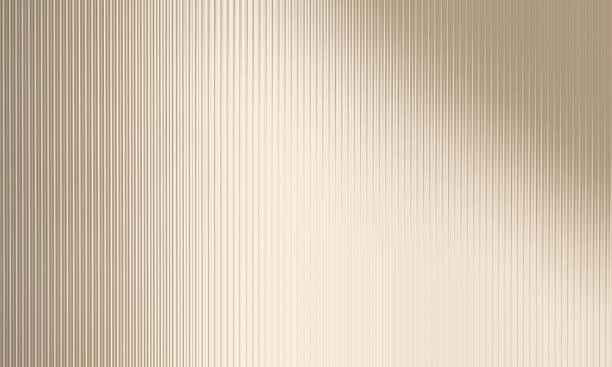 Modern and minimal reeded glass partition in sunlight on beige gold colored wall background stock photo