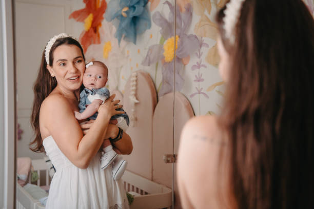 istock mother and daughter looking in the mirror 1443425778