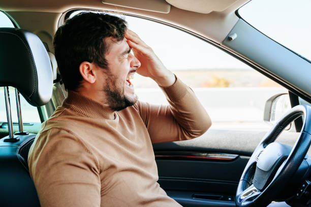 istock Side view wild cry and closed eyes, a hand on his forehead, a beard on his face, a headache. 1443427150
