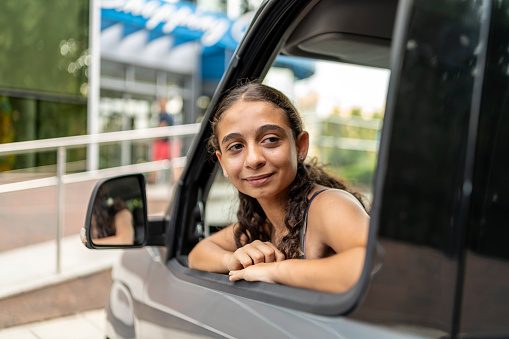 A teenage girl prepares for her driving test