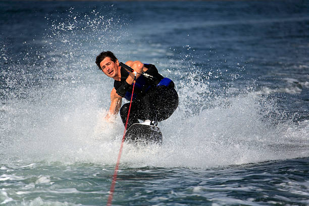 istock sliding wakeboarder with strained face and closed eyes 144342790