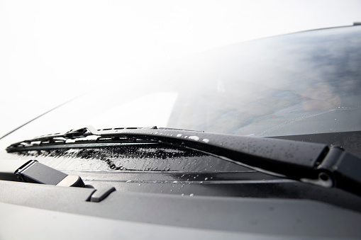Wiper blades work when cleaning a car's windshield.