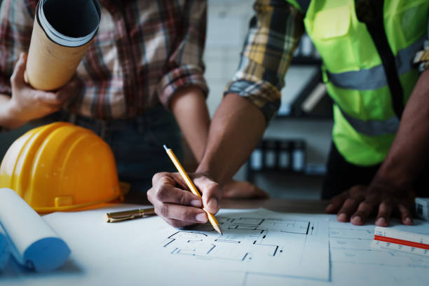 istock Engineers are consulting the team to design an architectural structure for clients with blueprints and building models to work at office 1443432945