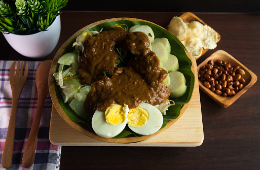 Gado-gado is an authentic Indonesian dish. It is made with mix vegetables, served with rice cake and savory-sweet peanut sauce.