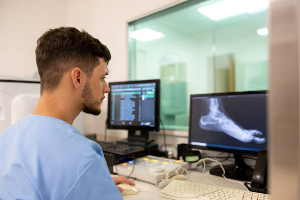 Radiologist working at the hospital taking an x-ray Radiologist working at the hospital taking an x-ray image of a foot injury - healthcare and medicine x ray image medical occupation technician nurse stock pictures, royalty-free photos & images