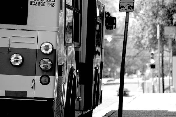 Bus on a bus stop in grayscale stock photo