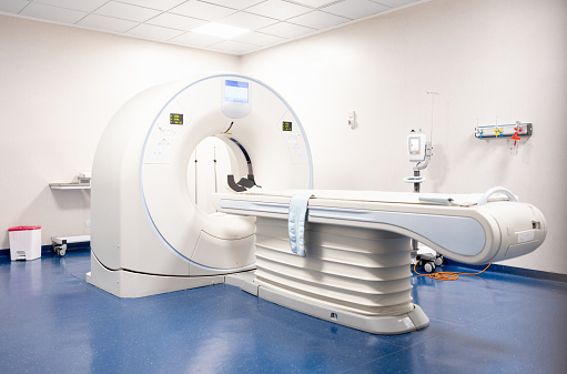 MRI scanner in an empty hospital room - healthcare and medicine concepts