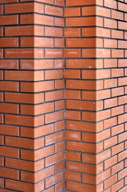 istock Bricks wall with different orange tones to be used as a background texture, digital graffiti or construction industry example. It is an image that shows solidity, strength, the human capacity. 1443436873