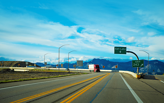 Red and white semi-truck driving mear Salt Lake in Utah, USA