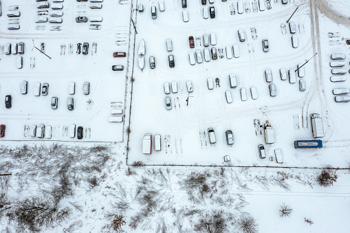outdoor parking lot with vacant parking places. aerial photography at winter day.