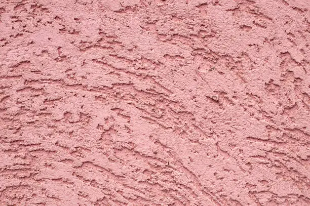 The surface of rough decorative sand-colored plaster