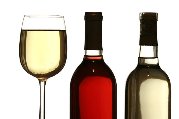 glasses of red and white wine with bottles stock photo