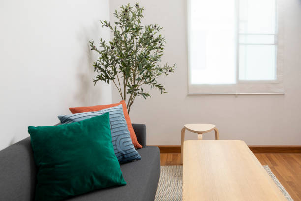 istock Modern living room with blue, orange and red pillow on sofa. 1443441302