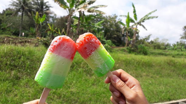 istock Fresh rainbow ice cream on hand with green background 1443441373