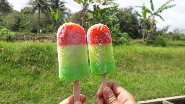 istock Fresh rainbow ice cream on hand with green view 1443441393