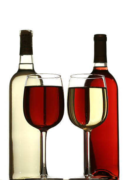 glasses of red and white wine with bottles stock photo