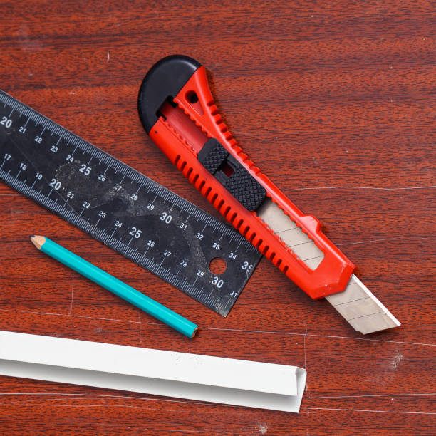 istock Construction or stationery knife, pencil and ruler on the board 1443443283