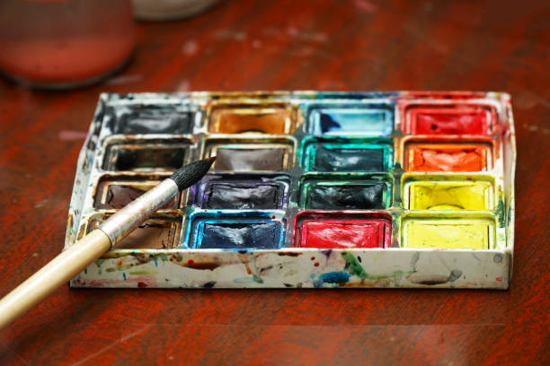 istock Watercolor paints and a brush on the table 1443443285