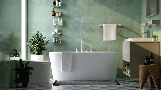 Baño de diseño moderno y de lujo con bañera, inodoro, tocador, lavabo, estante y toallero a la luz del sol desde la ventana sobre pared de granito verde y suelo de baldosas photo