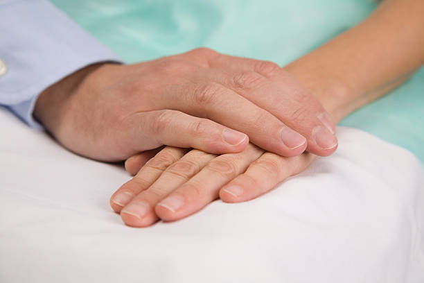 istock Hands clasping on hospital bed 144344951