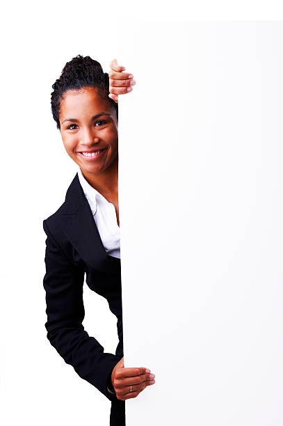 donna d'affari in piedi accanto a un cartellone - advertisement advertise businesswoman peeking foto e immagini stock