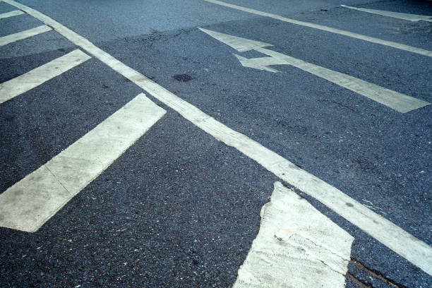 istock Close up White Arrow on Asphalt Road Background. 1443450206