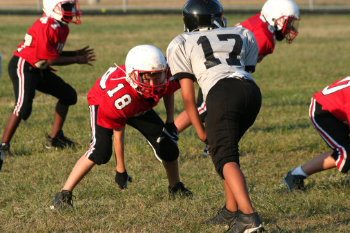 Youth football player in a middle of a game