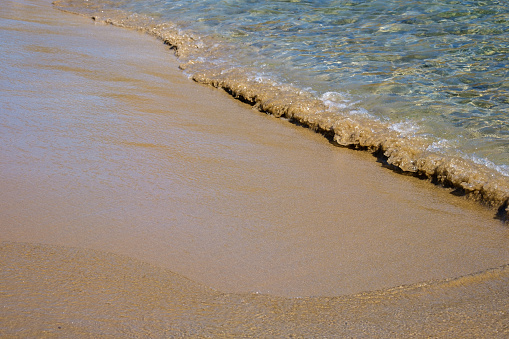 Close up of the beautiful sandy beach of Mylopotas in Ios Greece