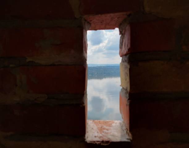 istock Lake seen through a window in the stone wall 1443455779