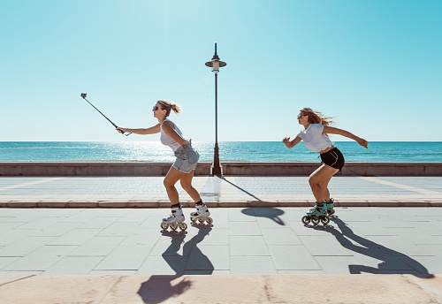 A young blonde women practicing sport outdoors on the seafront in summer