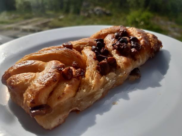 istock Closeup shot of a maple pecan pastry braid on a white plate 1443456176