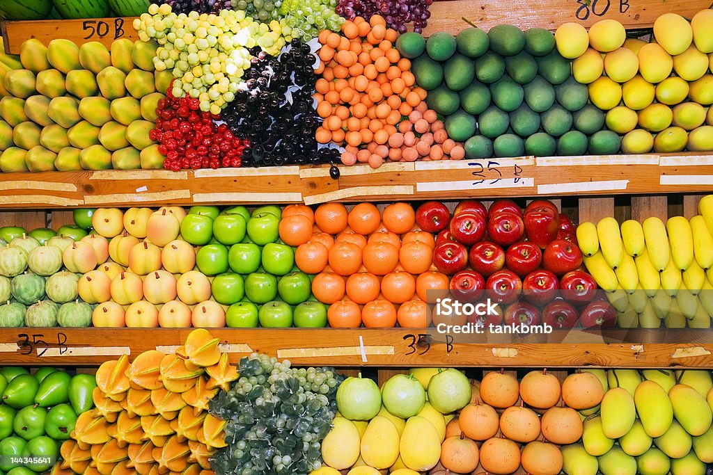 Thai Fruit Stand Variety of fruits and vegetables at fruit stand at Thai weekend market. Apple - Fruit Stock Photo