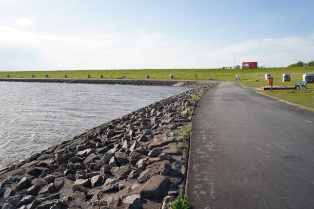 istock Stone seawall structure along the road 1443457401