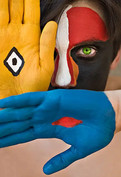 Young man with colorful painted face, conceptual