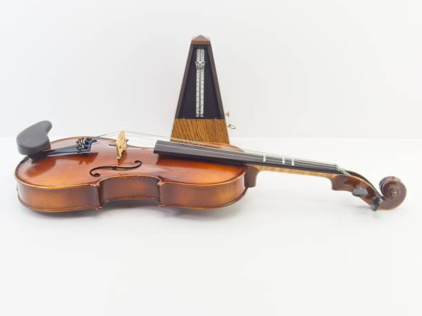istock fine acoustic violin on a white desk against bright white wall 1443458598
