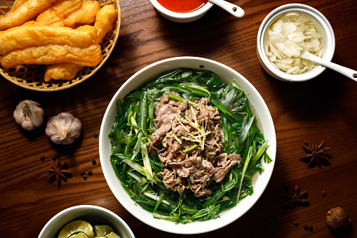 Phở Bò - Vietnamese beef broth noodle soup with fried dough sticks \