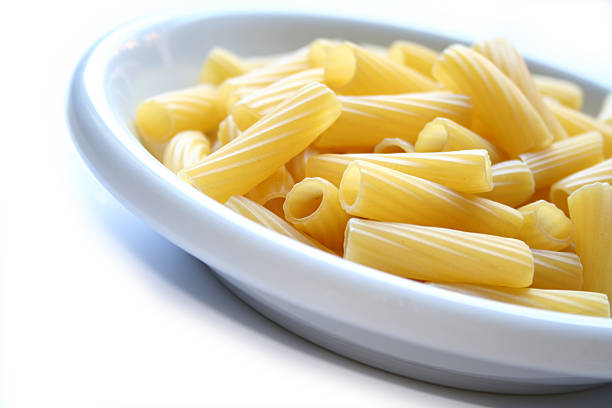 dish of pasta maccheroni rigatoni on the right stock photo