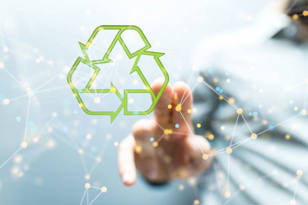 istock Hand touching a green recycling sign. 1443460051