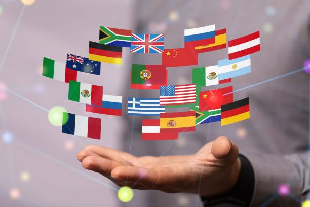 istock Flags of different countries hovering above the hand. 1443460063