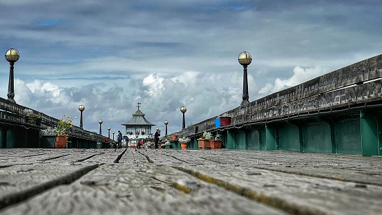 A low angle shot of the wooden Clevedon Pier under a bright sk